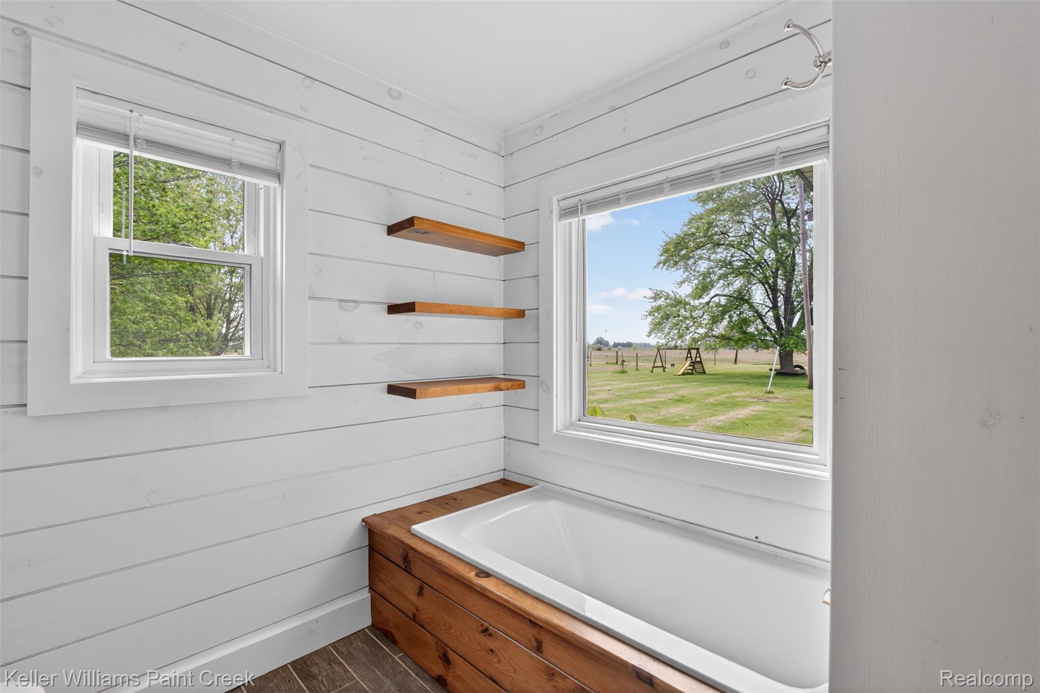 18125 Nelson Road St. Charles, MI 48655 - Photo 25 of 63 Full bathroom with a garden tub, wood finish floors, and wooden walls