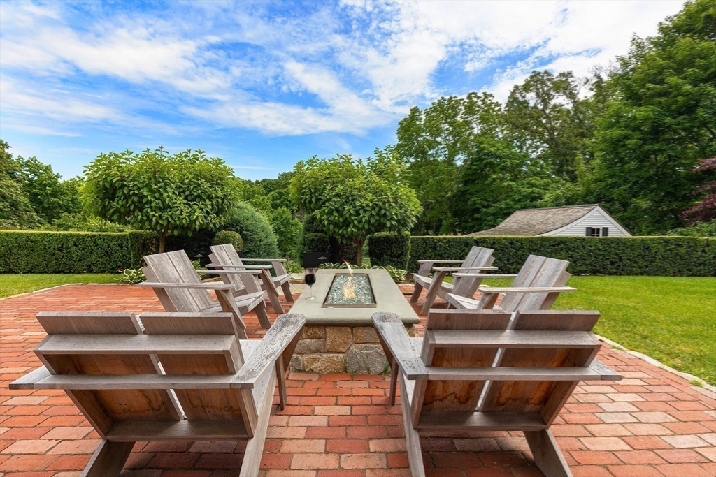 17 Cole Road Hingham, MA 02043 - Photo 24 of 29 a view of a patio with table and chairs with wooden floor and fence