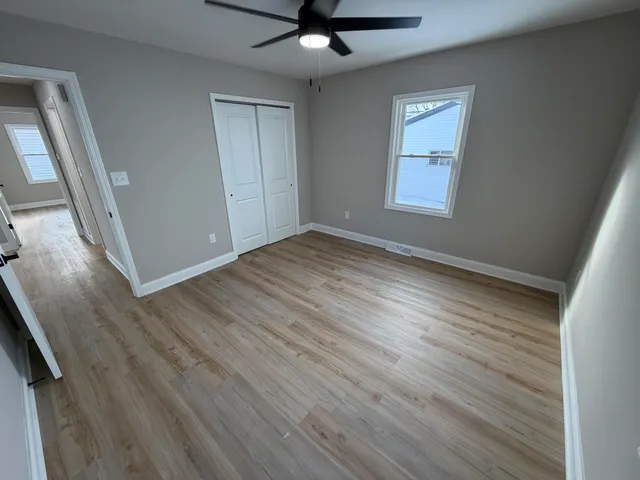 wooden floor in an empty room with a window