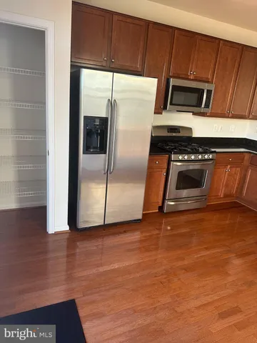 a metallic refrigerator freezer sitting in a kitchen
