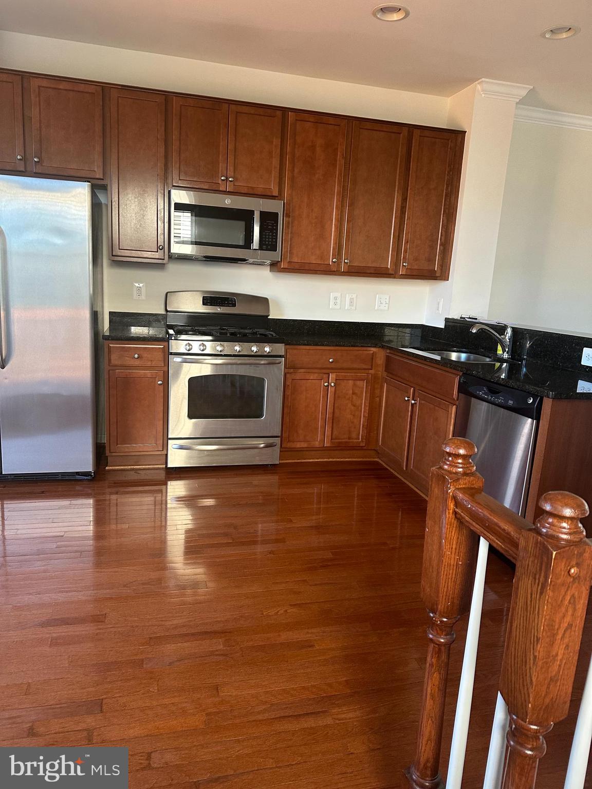 15715 John Diskin Circle Woodbridge, VA 22191 - Photo 12 of 21 a kitchen with granite countertop wooden cabinets and stainless steel appliances