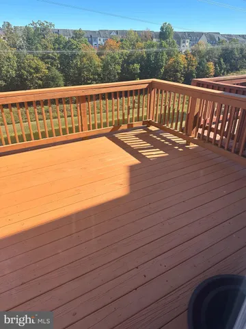a view of a balcony with wooden floor