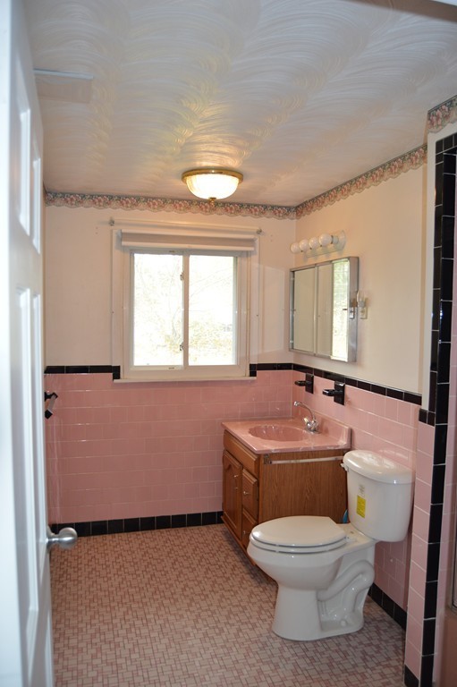 59 Joseph Road Framingham, MA 01701 - Photo 13 of 30 a bathroom with a granite countertop toilet a sink and a mirror