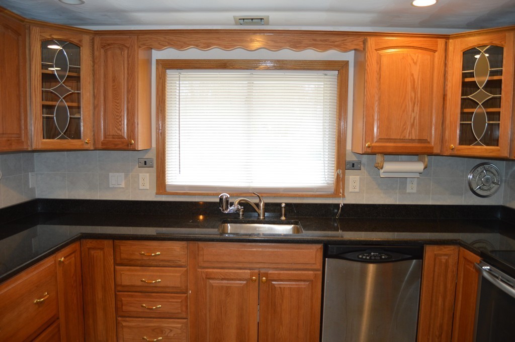 59 Joseph Road Framingham, MA 01701 - Photo 5 of 30 a kitchen with granite countertop a sink a stove and cabinets