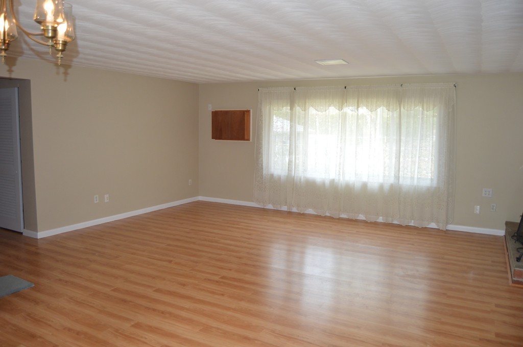 59 Joseph Road Framingham, MA 01701 - Photo 8 of 30 a view of an empty room with wooden floor and a window