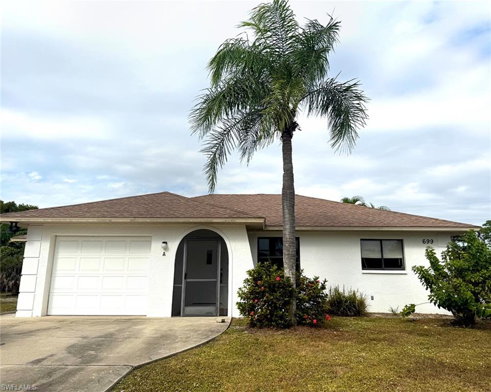 699 110th Avenue North, Unit A Naples, FL 34108 - Photo 2 of 15 a front view of a house with garden