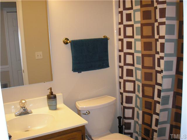 2654 Cottage Circle Raleigh, NC 27613 - Photo 12 of 17 a bathroom with a sink toilet and shower