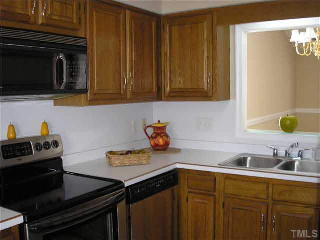 2654 Cottage Circle Raleigh, NC 27613 - Photo 2 of 17 a kitchen with a sink and cabinets