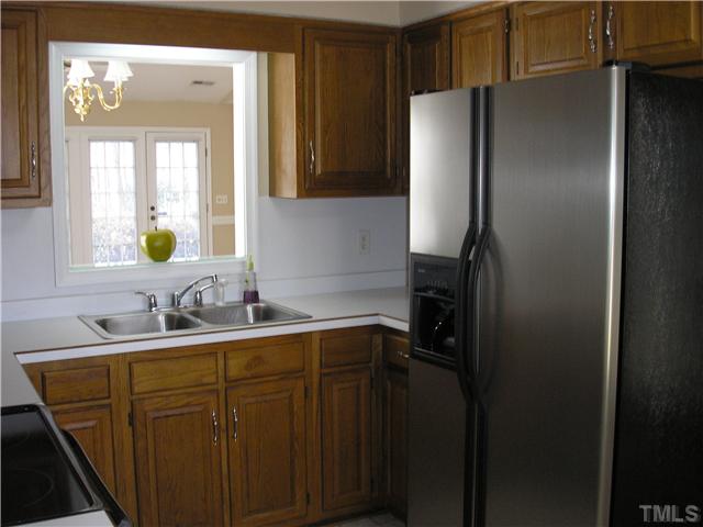 2654 Cottage Circle Raleigh, NC 27613 - Photo 3 of 17 a kitchen with a sink and refrigerator