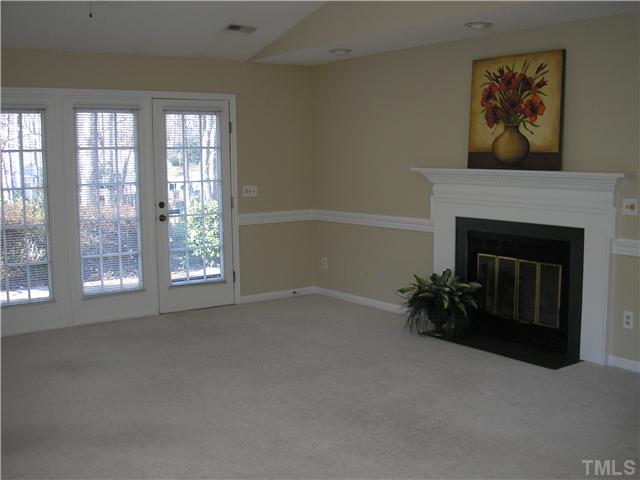 2654 Cottage Circle Raleigh, NC 27613 - Photo 6 of 17 an empty room with windows and fireplace