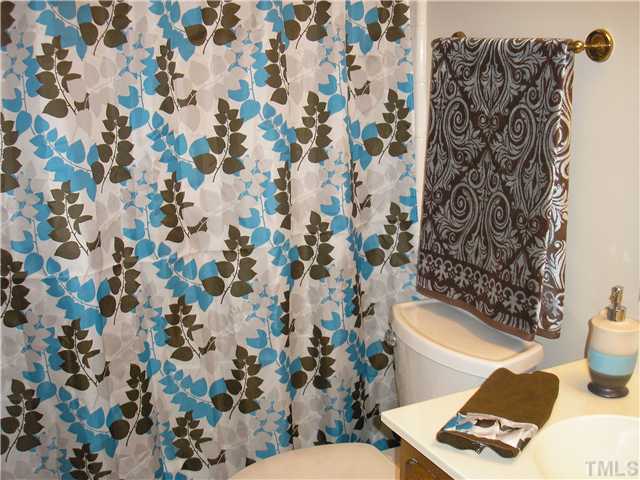 2654 Cottage Circle Raleigh, NC 27613 - Photo 10 of 17 a bathroom with a toilet and a shower curtain