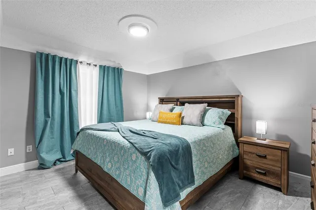 a bedroom with a bed and a mirror