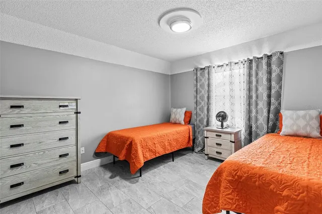 a bedroom with two beds and lamp