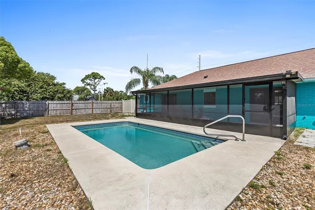 swimming pool view with a seating space