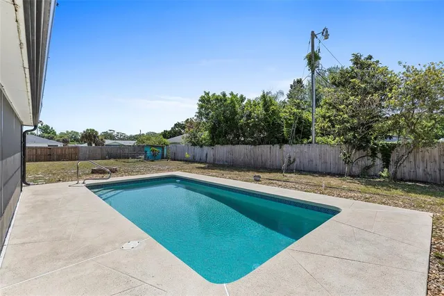 a view of a swimming pool and lounge chair