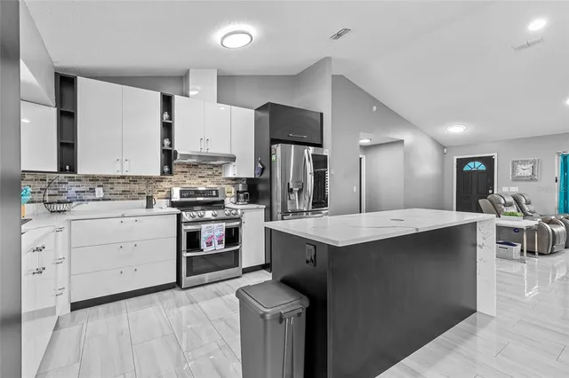 a kitchen with a stove sink and a refrigerator