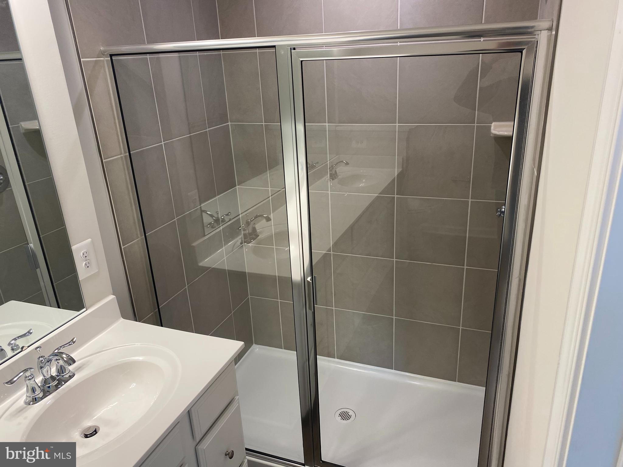 7911 Independence Drive, Unit 1C Spotsylvania, VA 22553 - Photo 15 of 35 a bathroom with a sink and a shower