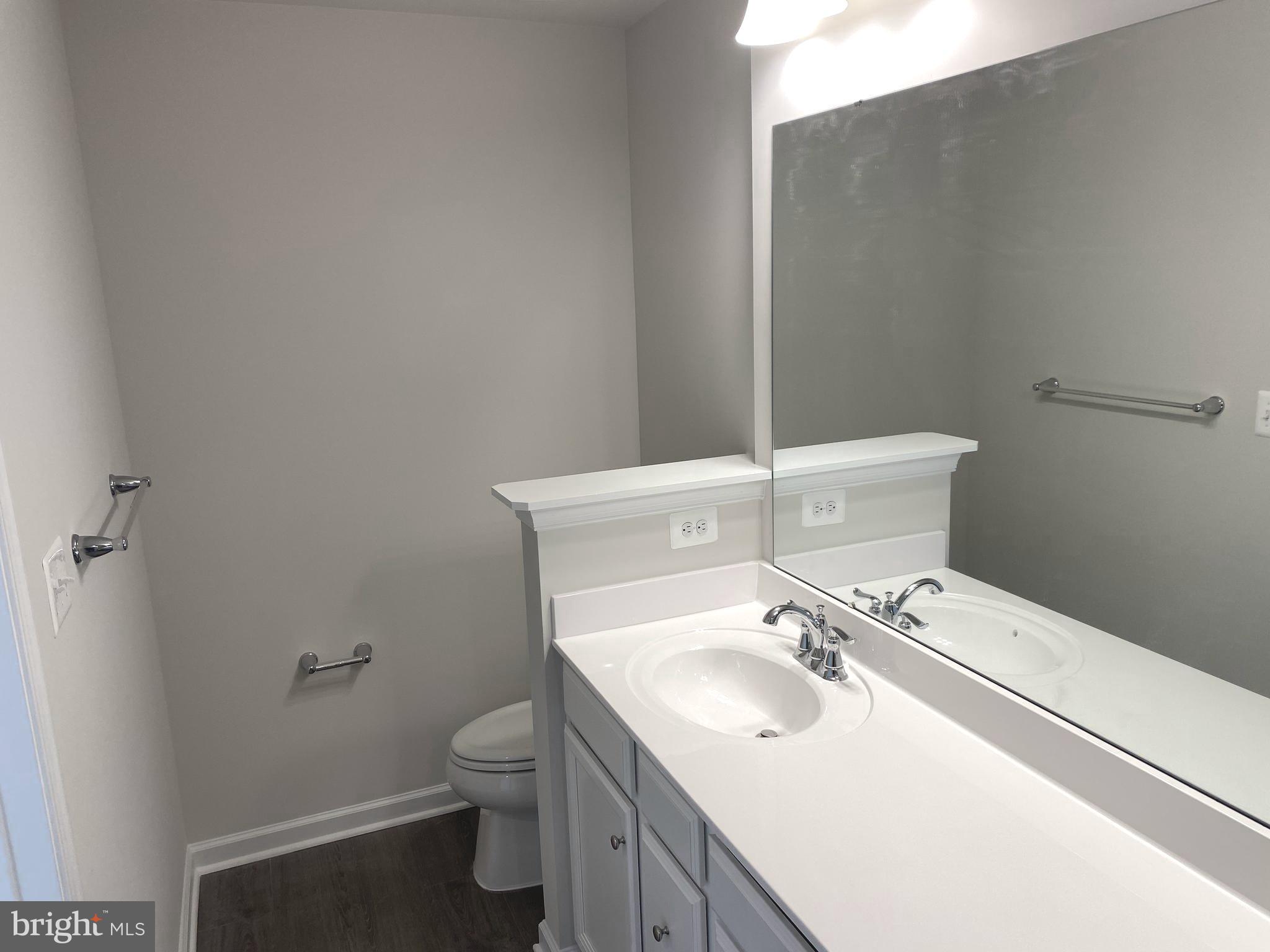 7911 Independence Drive, Unit 1C Spotsylvania, VA 22553 - Photo 16 of 35 a bathroom with a sink toilet and a mirror
