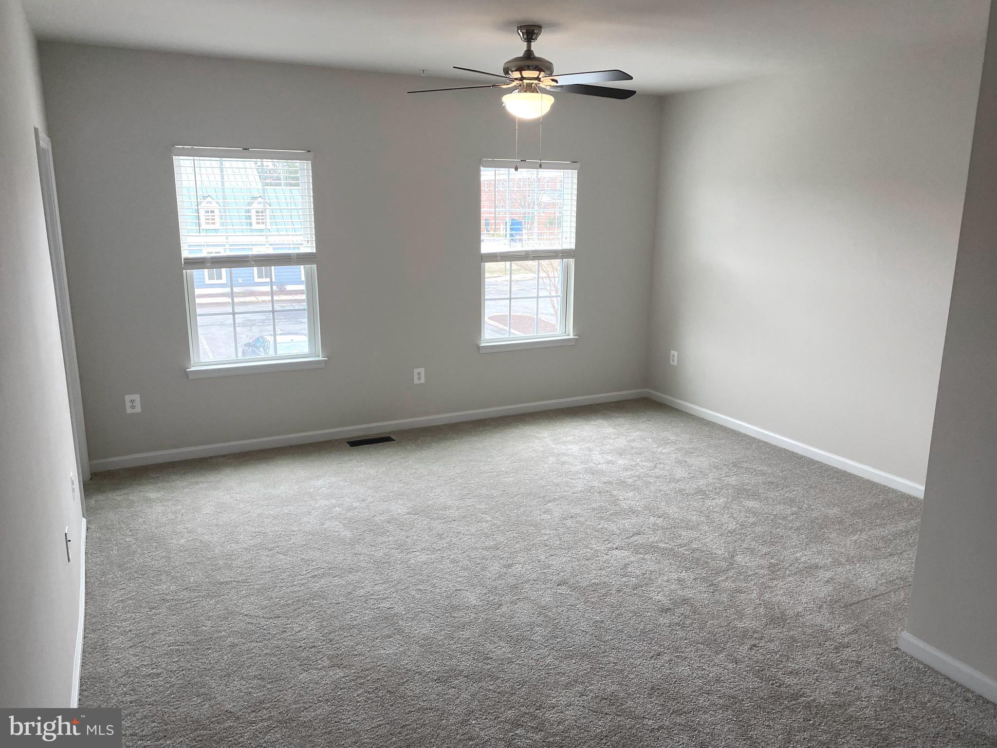 7911 Independence Drive, Unit 1C Spotsylvania, VA 22553 - Photo 19 of 35 an empty room with a window and a ceiling fan