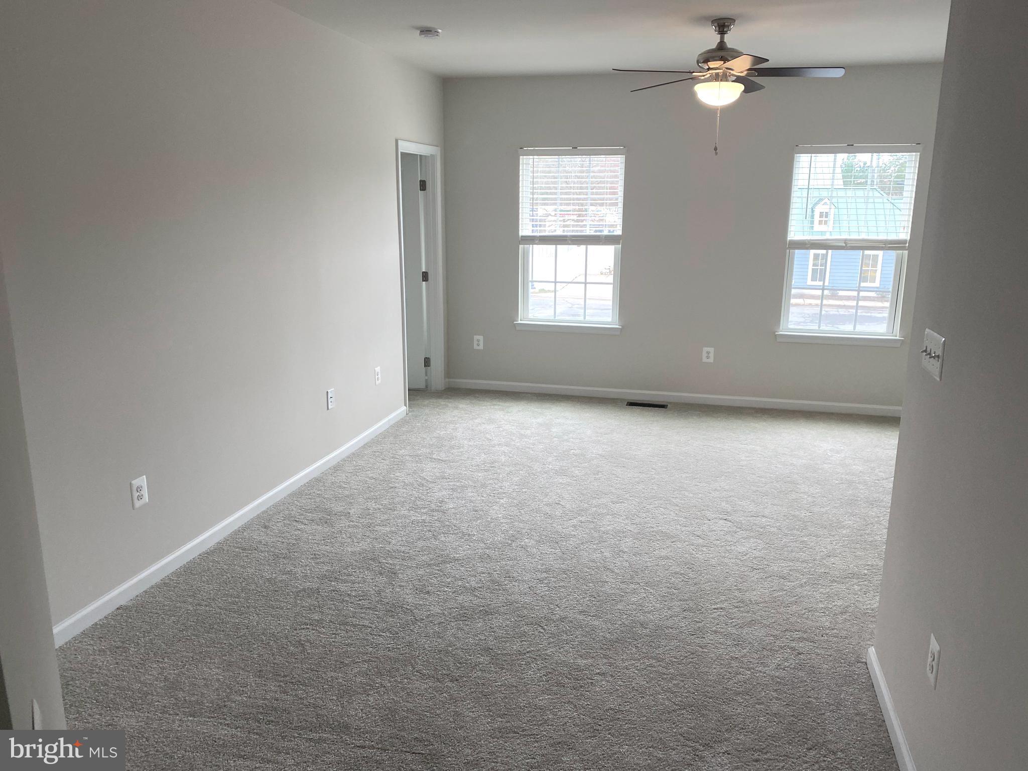 7911 Independence Drive, Unit 1C Spotsylvania, VA 22553 - Photo 20 of 35 an empty room with windows and chandelier fan