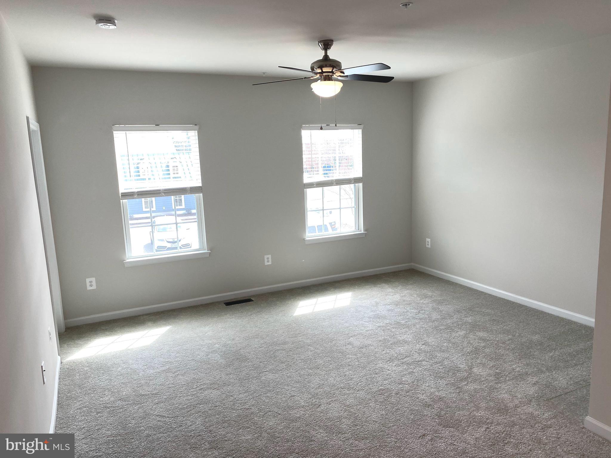 7911 Independence Drive, Unit 1C Spotsylvania, VA 22553 - Photo 21 of 35 an empty room with a window and a fan