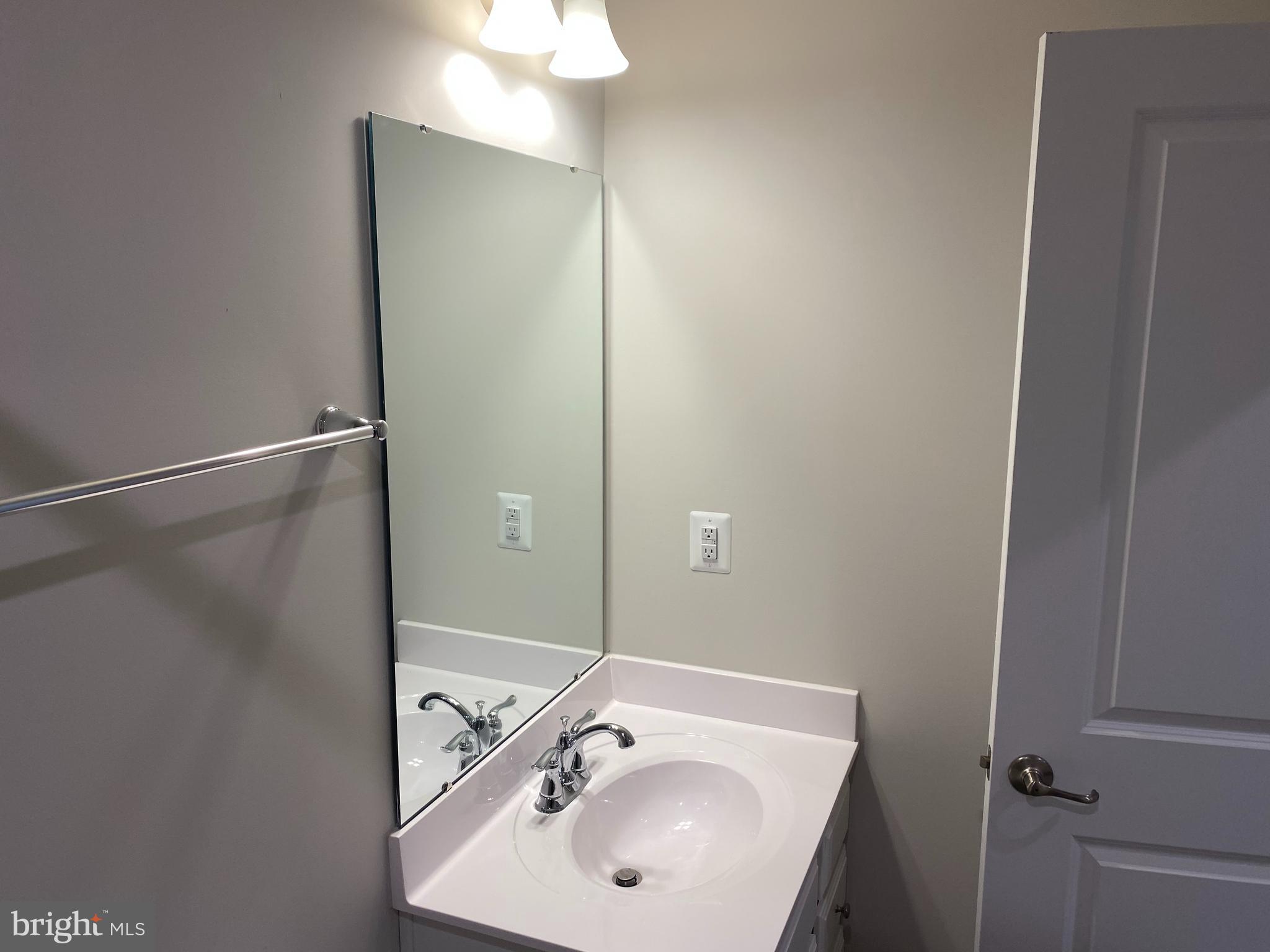 7911 Independence Drive, Unit 1C Spotsylvania, VA 22553 - Photo 27 of 35 a bathroom with a sink and mirror