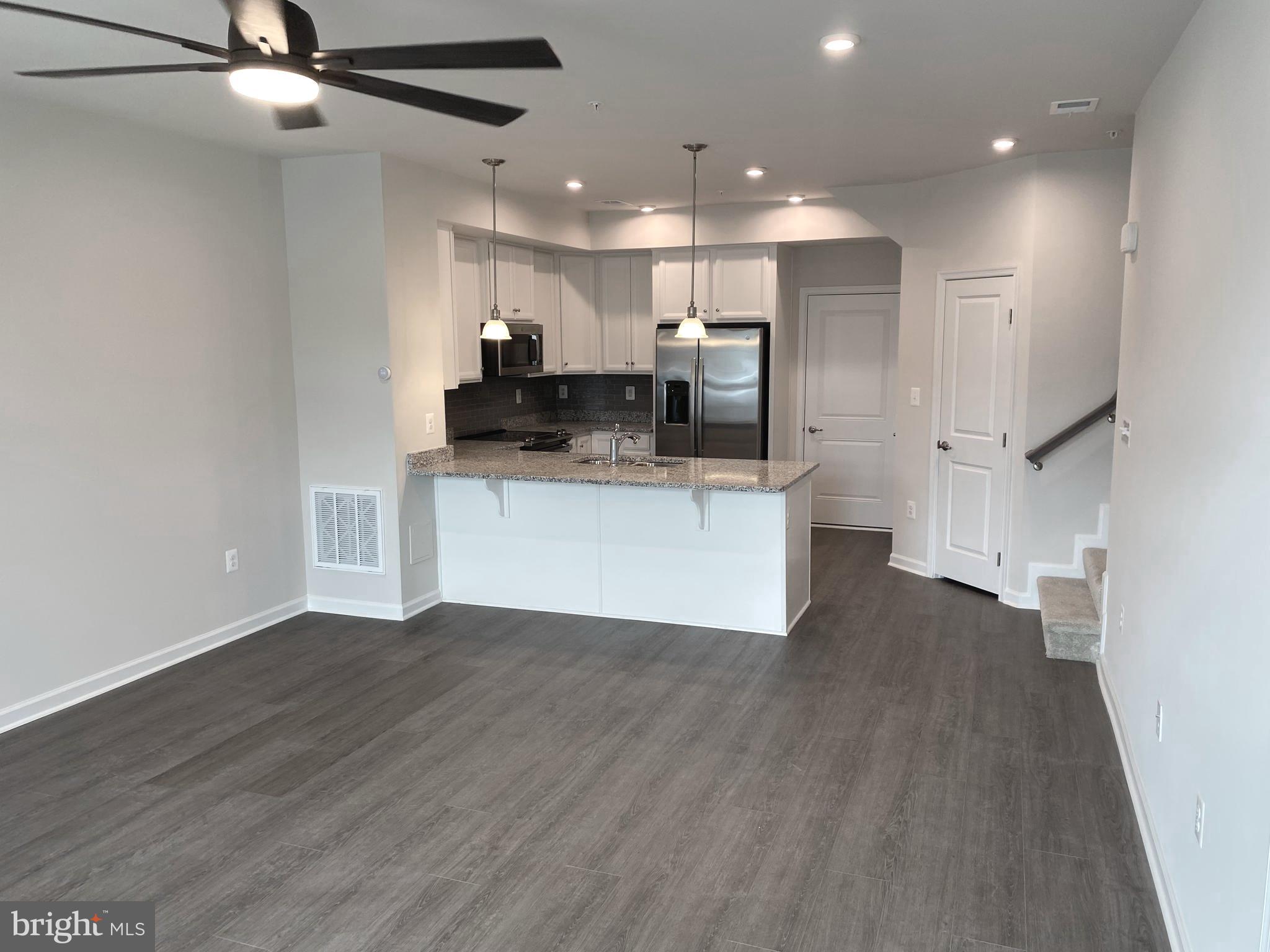 7911 Independence Drive, Unit 1C Spotsylvania, VA 22553 - Photo 3 of 35 a view of kitchen with stainless steel appliances refrigerator stove microwave and cabinets
