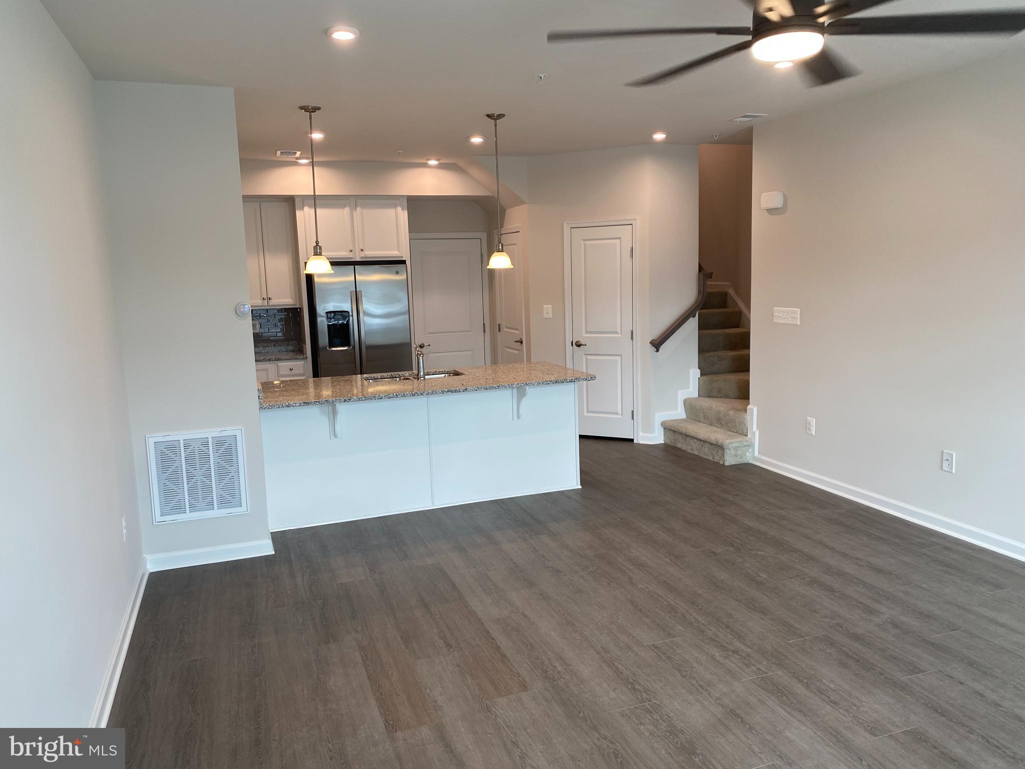 7911 Independence Drive, Unit 1C Spotsylvania, VA 22553 - Photo 5 of 35 a view of a kitchen with a sink and a microwave