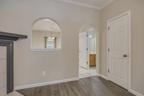 an empty room with a ceiling fan and a window