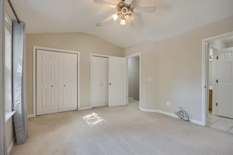 a view of a house with a wooden fence