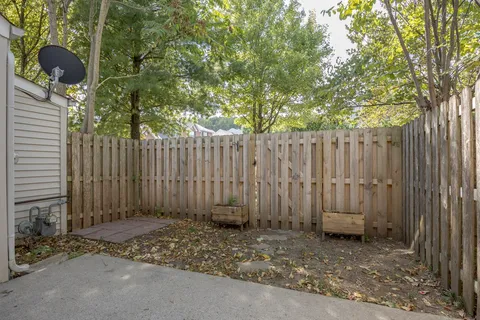 front view of a brick house with potted plants