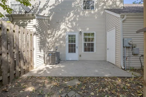 a front view of a house with yard and green space