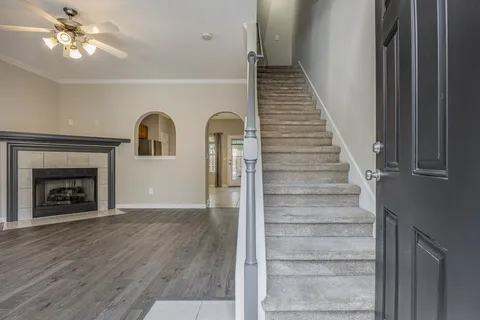 wooden floor chandelier and a fireplace