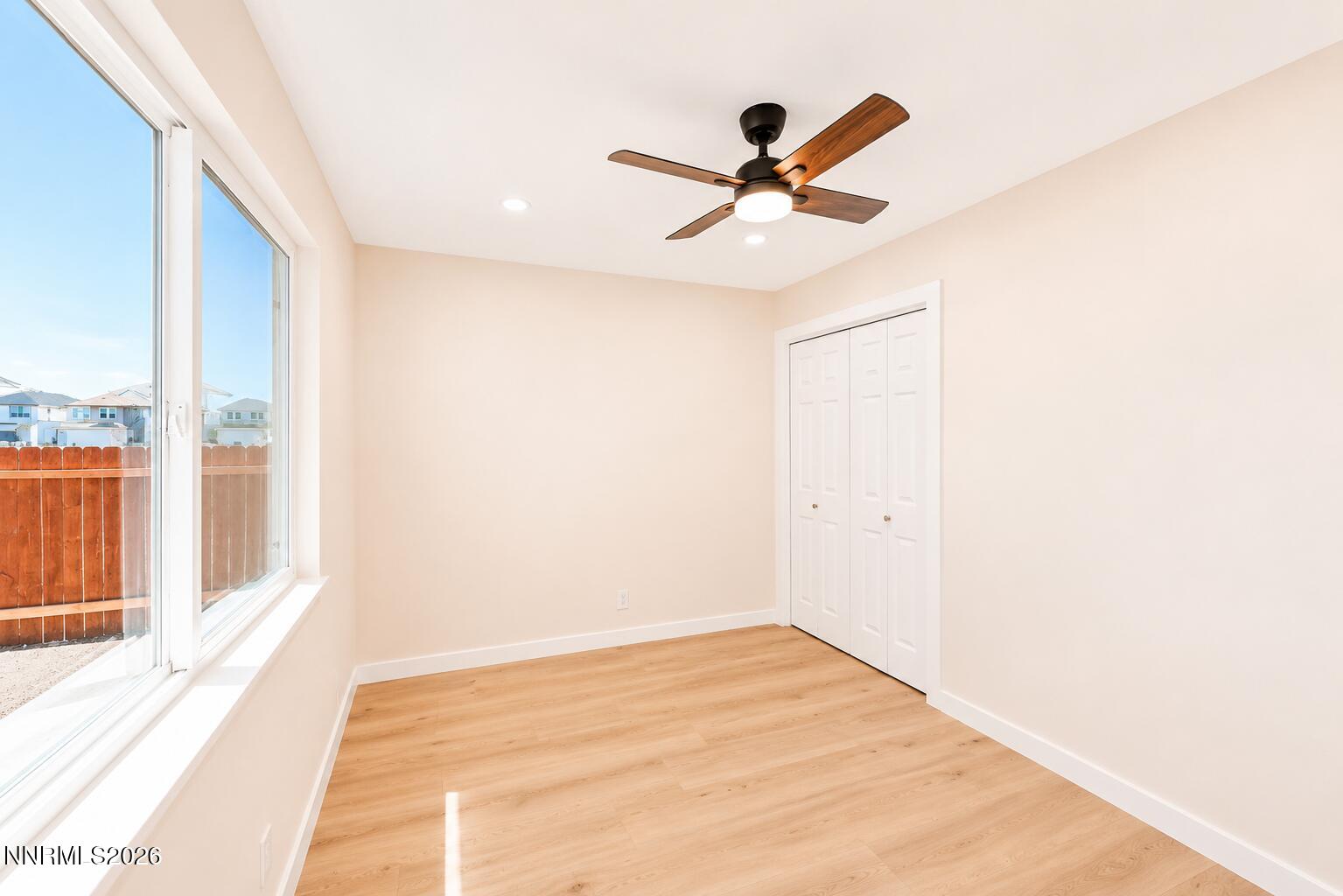 742 Ruth Street Carson City, NV 89701 - Photo 18 of 25 a view of a big room with wooden floor closet and windows