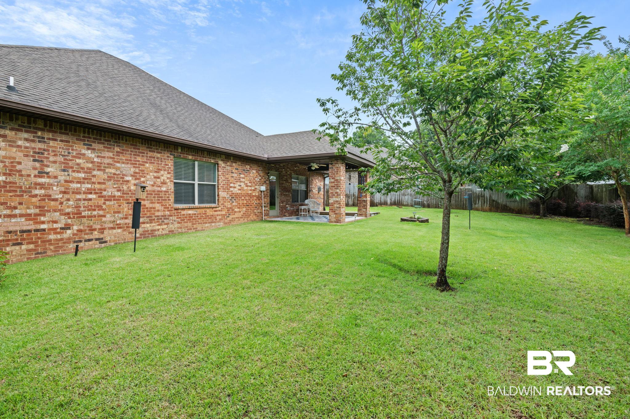 2554 Masters Court Mobile, AL 36618 - Photo 34 of 35 Fenced backyard featuring a patio and a ceiling fan