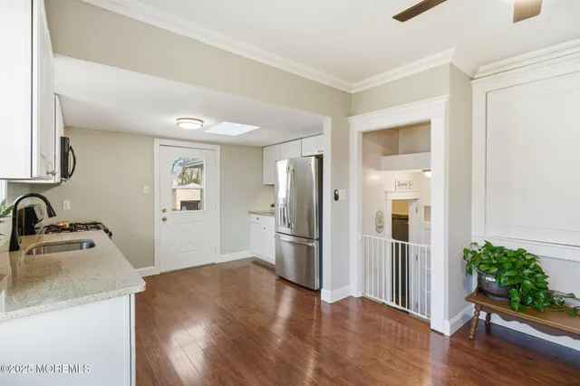 a kitchen with a refrigerator and a sink