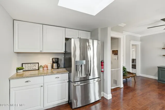 a kitchen with stainless steel appliances a refrigerator sink and cabinets