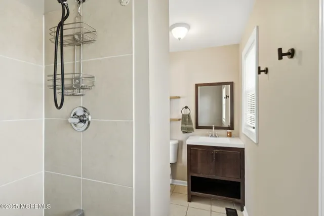 a bathroom with a shower and a mirror