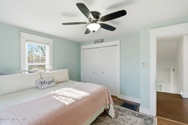 a bedroom with a large bed and a ceiling fan