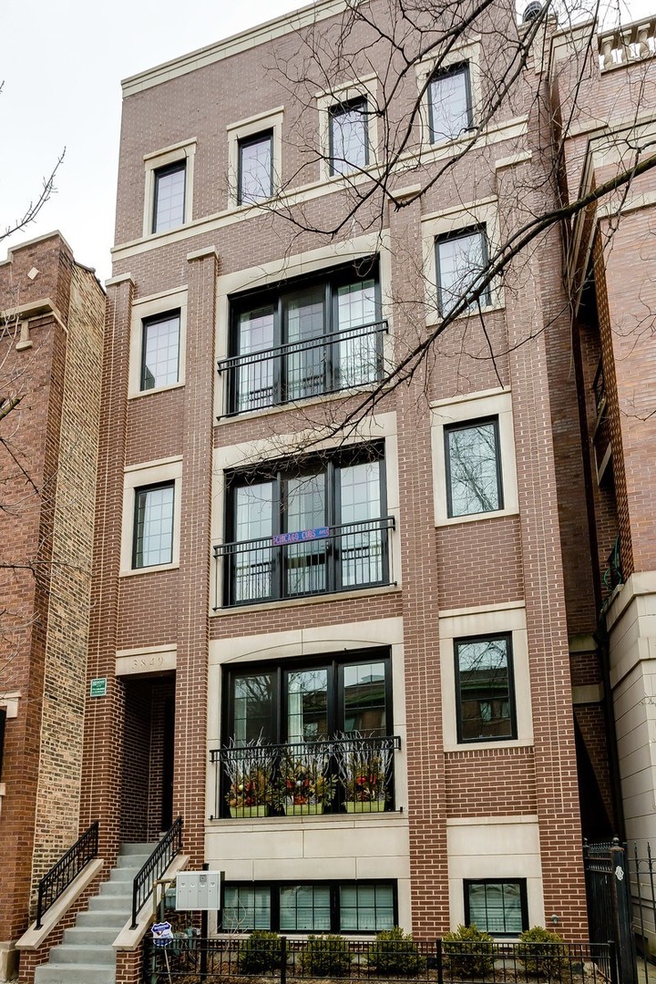 a front view of a residential apartment building with a yard