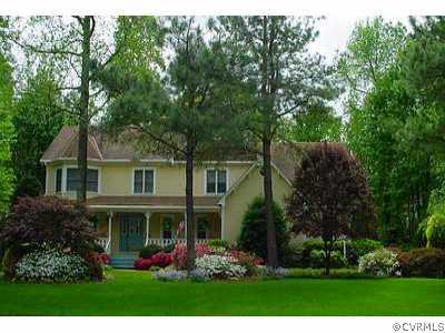 a front view of house with a garden