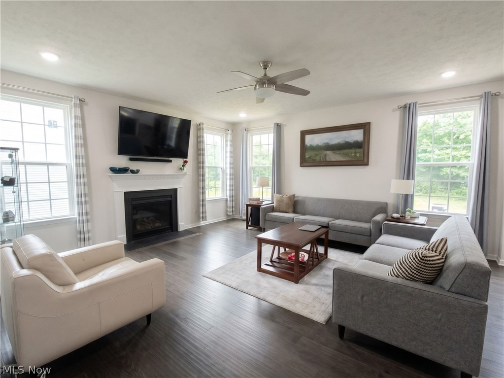 4509 Millbrook Way Akron, OH 44321 - Photo 10 of 27 Spacious living area featuring dark wood-finish flooring, a white mantel fireplace, and recessed lighting