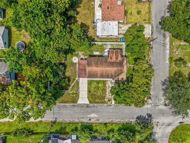 an aerial view of a house with a yard and garden