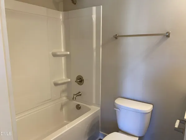 a bathroom with a toilet and a bathtub