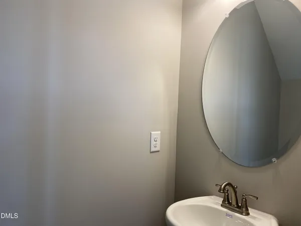 a bathroom with a sink and mirror