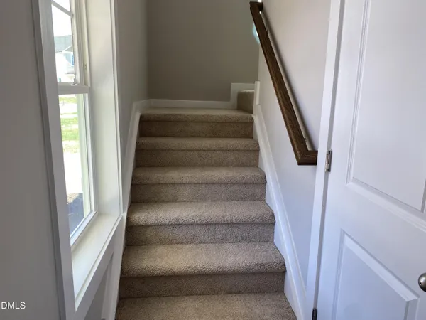 a view of staircase with white walls and windows