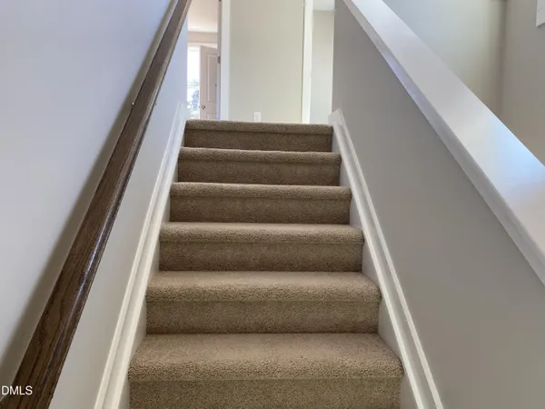 a view of staircase with white walls