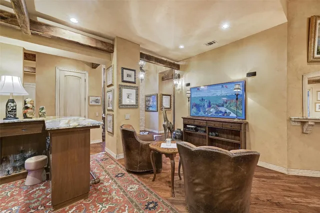 a living room with furniture a rug and a painting