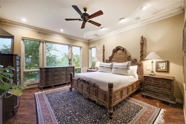 a bedroom with a large bed and a chandelier