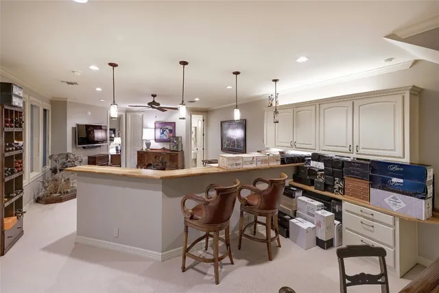 a kitchen with stainless steel appliances granite countertop a sink a stove a dining table and chairs